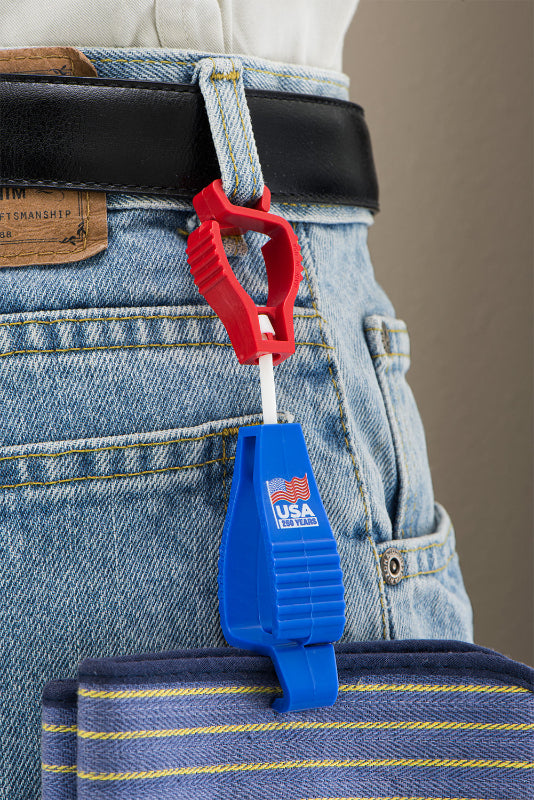 Blue and red tool clip attached to a belt with jeans